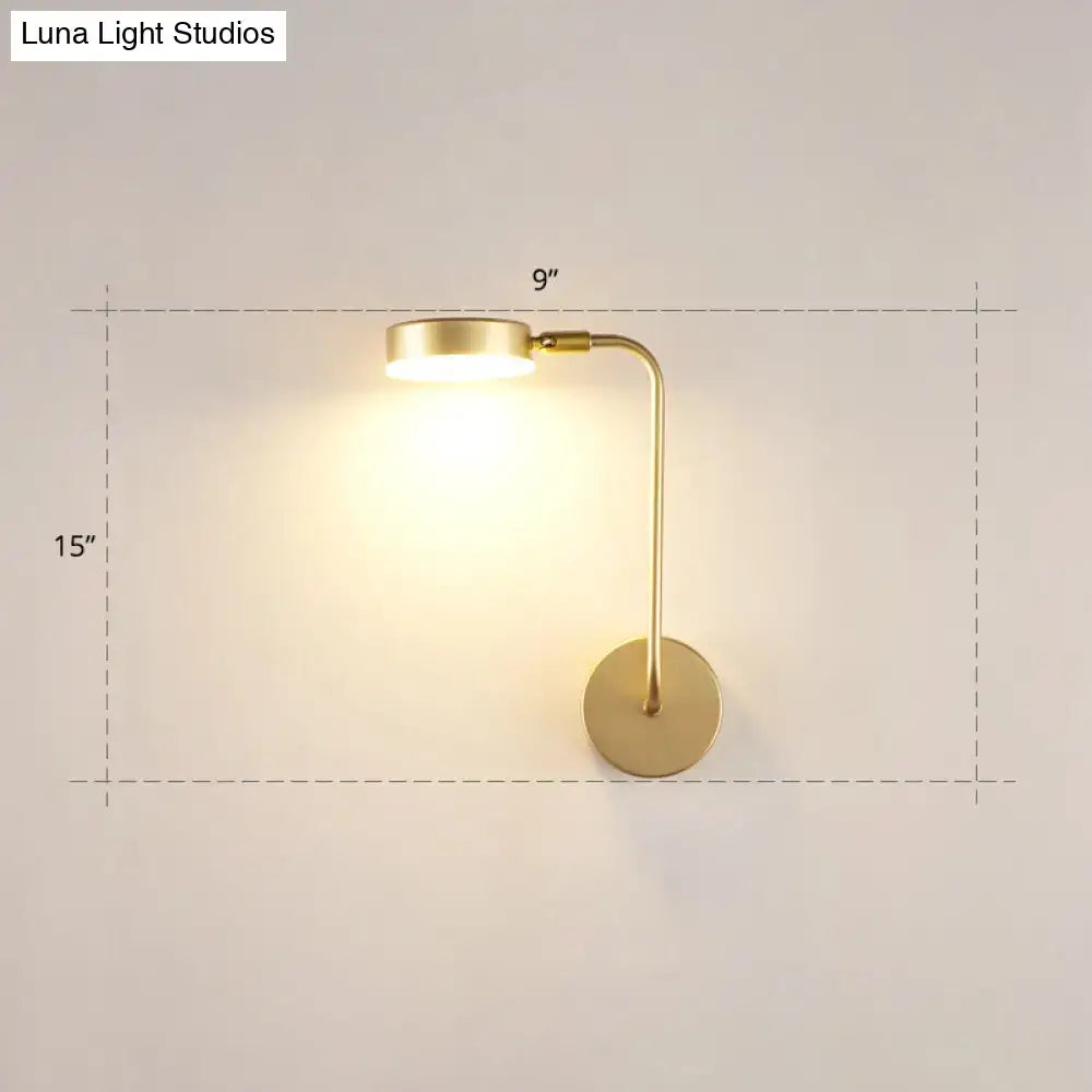 Minimalist gold metal led sconce wall mounted lamp with sleek curved arm and circular base for bedroom use
