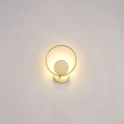 Minimalist gold metal led sconce wall mounted lamp with circular frame and concentric design for bedroom