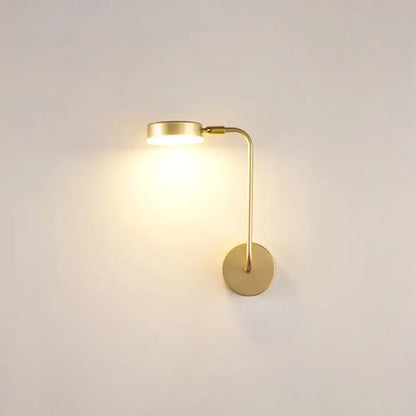 Minimalist gold metal led sconce with a slender curved arm and circular base wall mounted lamp for bedroom
