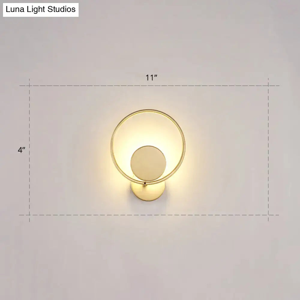 Minimalist gold metal led sconce wall mounted lamp with circular frame and concentric ring design for bedroom