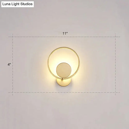 Minimalist gold metal led sconce wall mounted lamp with circular frame and concentric ring design for bedroom