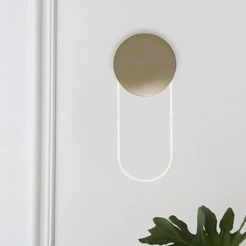 Minimalist gold metal oval wall lamp with a brushed gold pull handle and illuminated curved white led light fixture