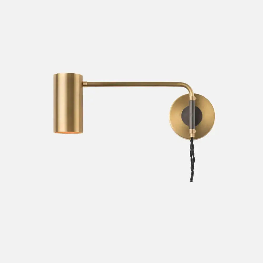 Minimalist brass-finished wall lamp with cylindrical shade and black twisted cord bedside spotlight for bedroom