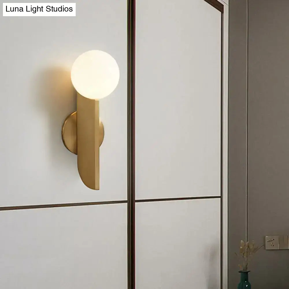 Minimalist gold mini globe wall sconce with spherical frosted glass bulb and sleek gold tone for bedroom lighting