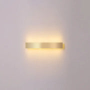 A minimalist gold plated rectangular led wall sconce with warm ambient light for living room and bar use