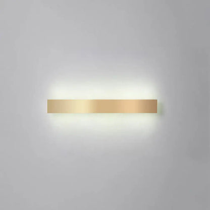 A sleek minimalist gold plated led wall sconce with a rectangular design for living room or bar lighting