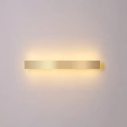 A sleek rectangular minimalist gold plated led wall sconce with gold toned finish for living room or bar lighting