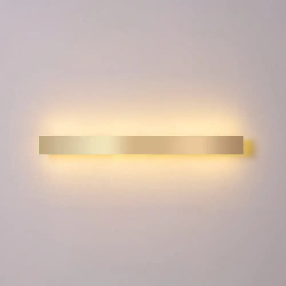 Minimalist gold plated rectangular wall sconce with a warm glow for living room and bar lighting