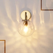 DecorBites minimalist rippled glass sphere wall lamp with warm-toned textured glass and brass-finished gold sconce lighting