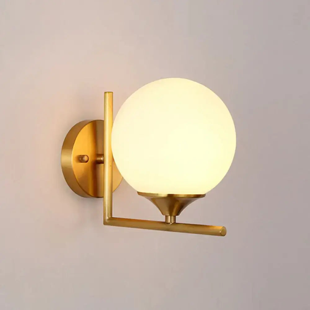 Minimalist gold sphere wall mounted light with frosted glass globe and metal frame for bedroom mounted light