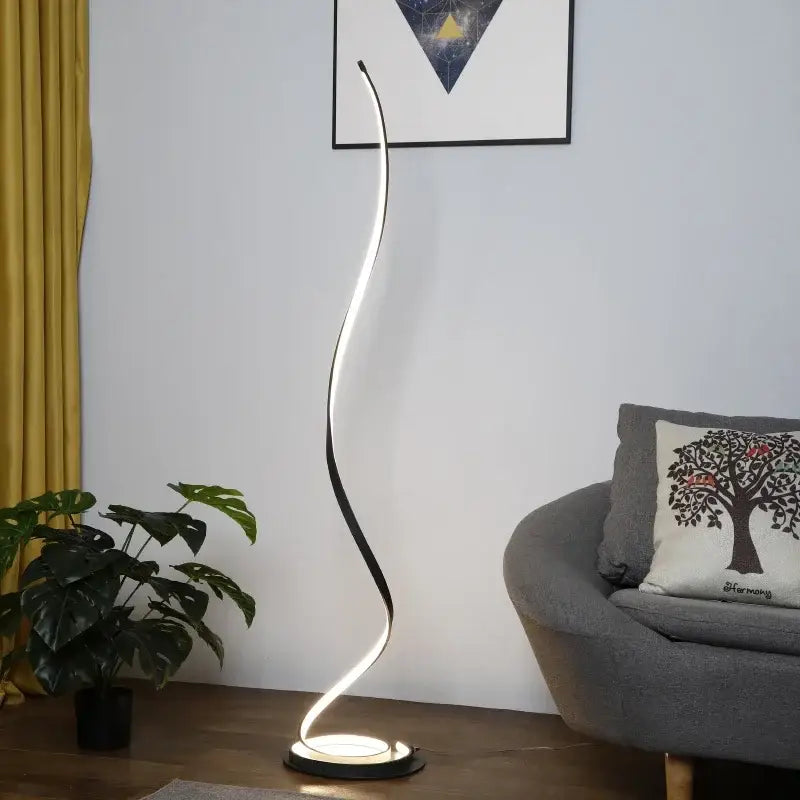 Minimalist standing lamp with sleek curved design and warm white led light strip in black and gold for living room use