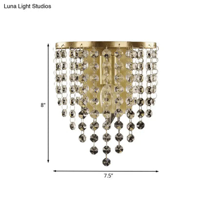 Minimalist gold wall sconce with cascading crystal beads in clear and dark tones for elegant bedroom lighting
