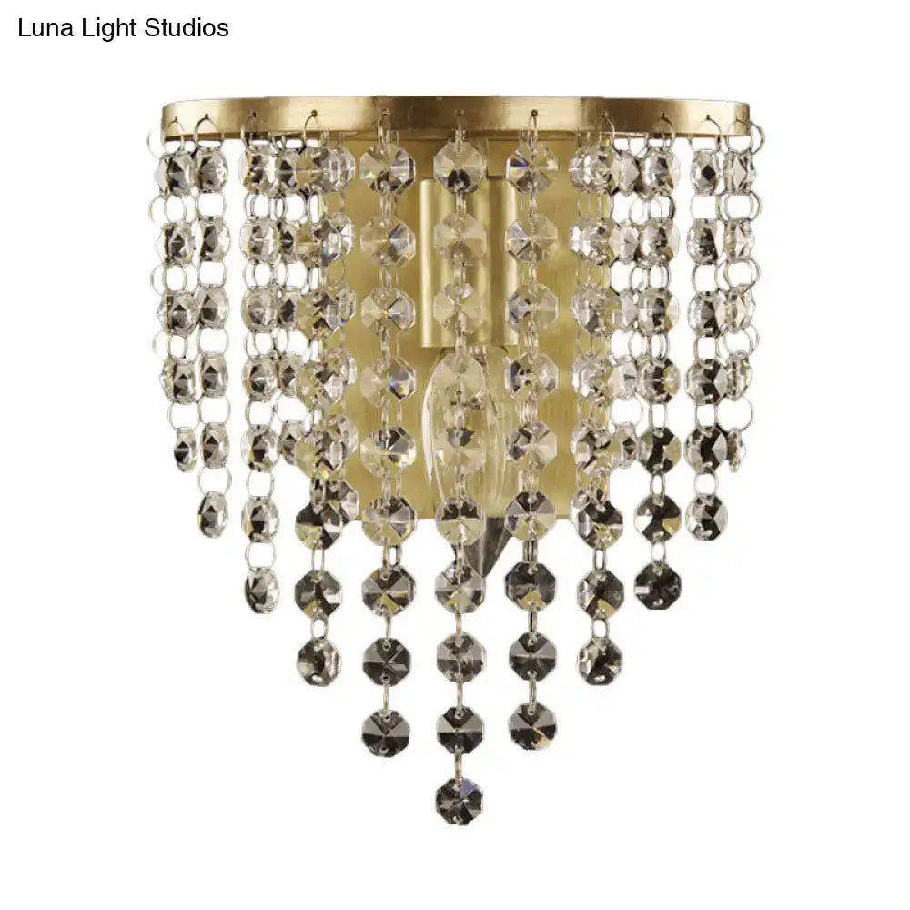 Minimalist gold wall sconce featuring a gold-toned crystal chandelier with cascading clear and dark faceted beads