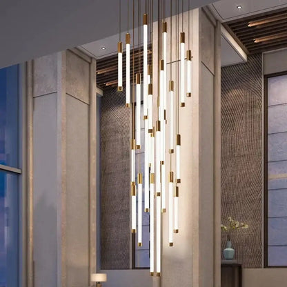 Modern gold-accented linear pendant light fixture with glowing white tubes for elegant led chandelier in living room