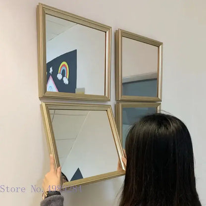 Minimalist rectangular mirror wall decor with gold-framed golden border and subtle metallic sheen for living room use