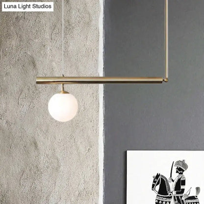 Modern brass pendant light with frosted glass globe bulb from DecorBites™ designed for dining room illumination