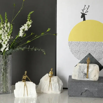 Minimalist golden man sculpture bookends with gold figurine sculptures on white rock bases for home decor by decorbites