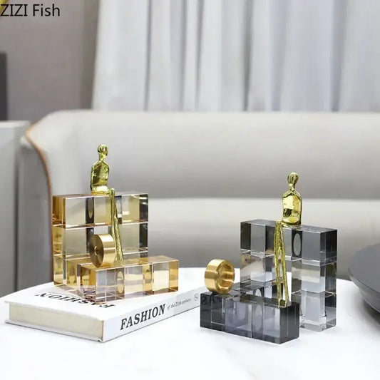 Gold-toned minimalist thinker crystal base sculpture seated on transparent stacked acrylic cubes for office decorbites golden thinker