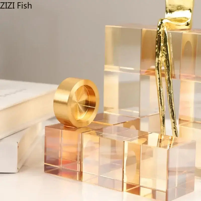 Minimalist golden thinker crystal base sculpture featuring a polished golden metallic ring on transparent acrylic cubes for office decorbites decor