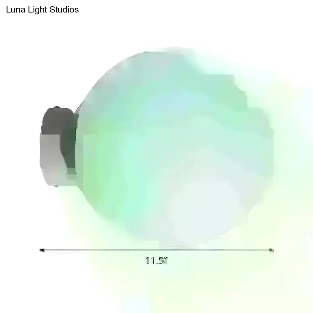 Minimalist green glass spherical sconce light with a translucent globe and metallic base, 11.5 inches diameter