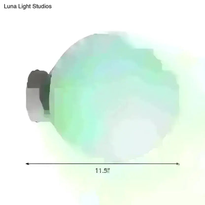 Minimalist green glass spherical sconce light with a translucent globe and metallic base, 11.5 inches diameter