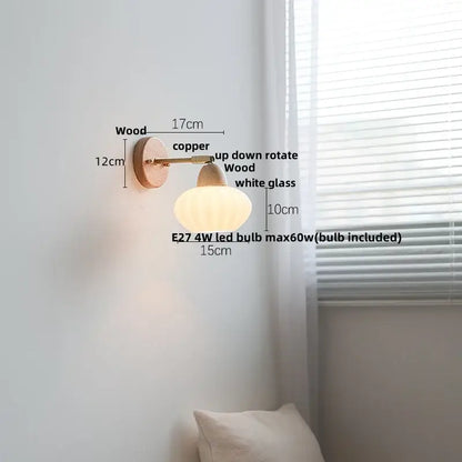 A warm-toned minimalist iron wood led wall lamp with wooden base copper arm and white glass shade for bedroom decorbites
