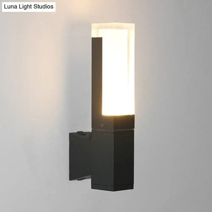Minimalist led black wall lamp with rectangular frosted glass diffuser emitting warm white light for courtyard use
