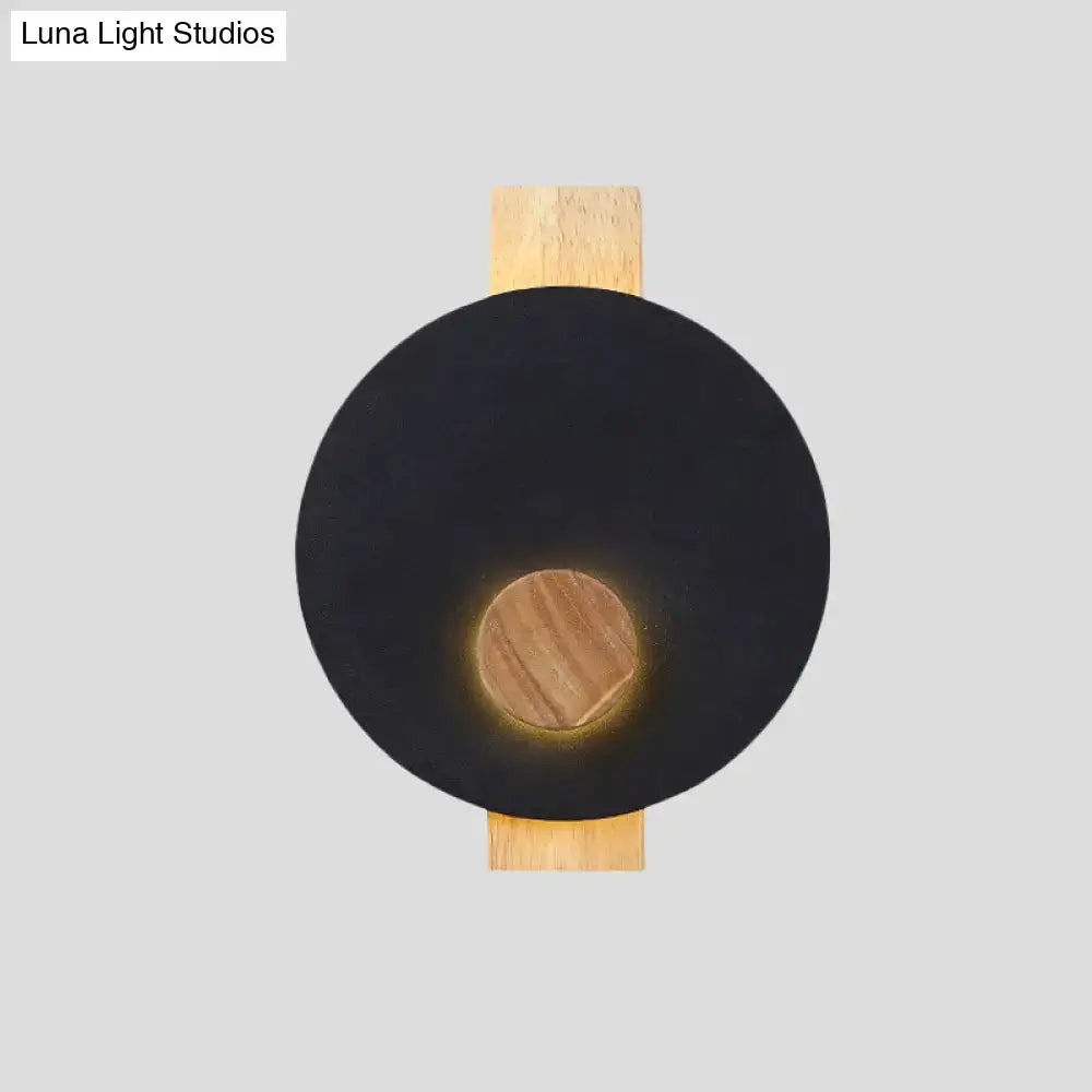 Minimalist led 110v-120v black circular wall sconce with warm wood-toned accent and natural wood mounting plate fixture width