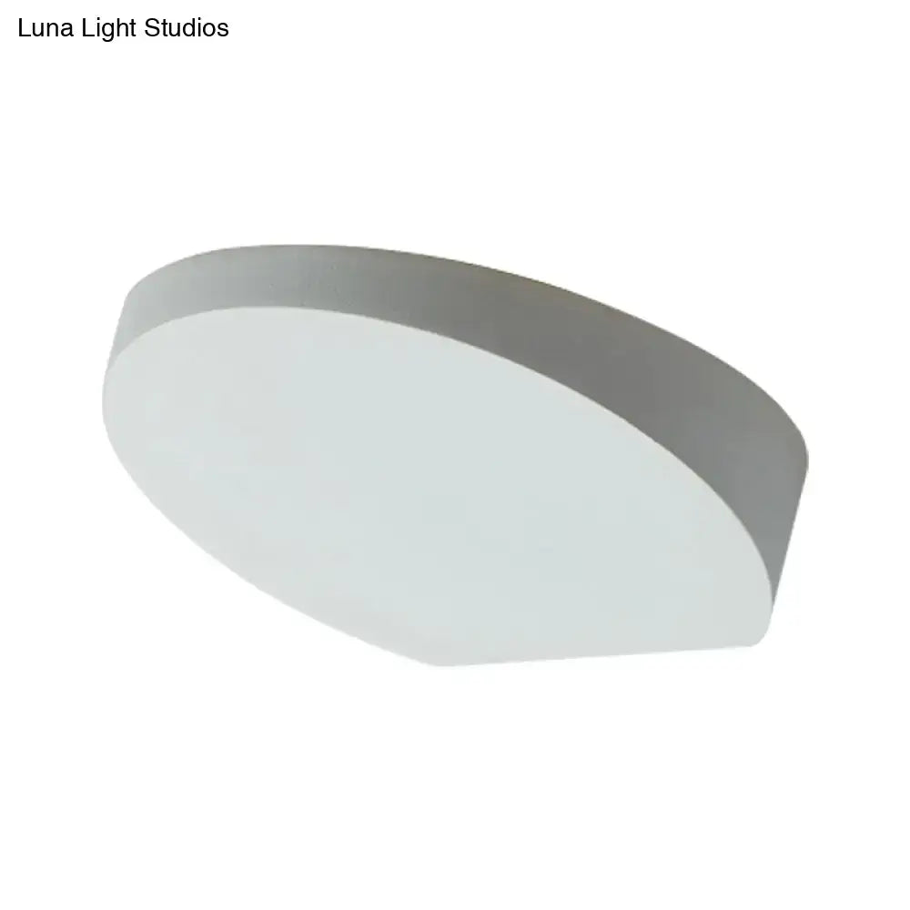 Minimalist led oval wall sconce with matte grey aluminum finish and softly diffused light bulb for corridor lighting