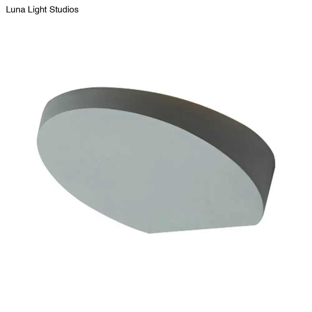 A minimalist led oval wall sconce with matte gray aluminum finish and sleek design for corridor lighting with light bulb