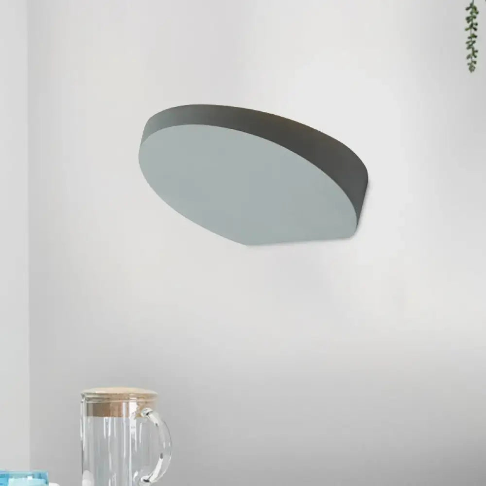 Minimalist led oval wall sconce in grey aluminum with matte finish and sleek design featuring a light bulb for corridors