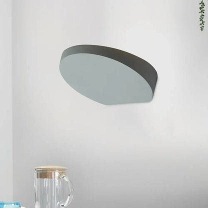 Minimalist led oval wall sconce in grey aluminum with matte finish and sleek design featuring a light bulb for corridors