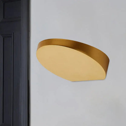 Gold-colored minimalist led oval wall sconce with sleek curved design in aluminum for corridor lighting with light bulb