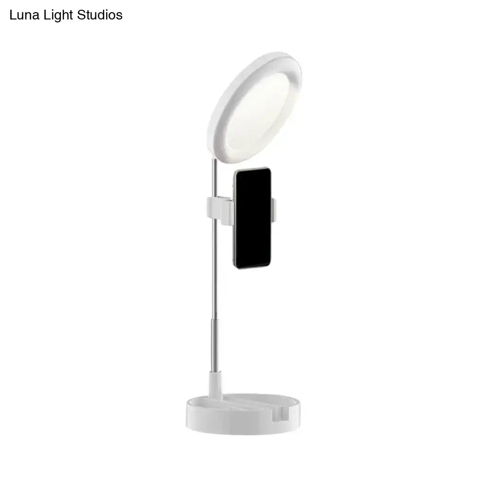 Minimalist white led ring light with adjustable stand and phone holder for bedroom use with usb power source
