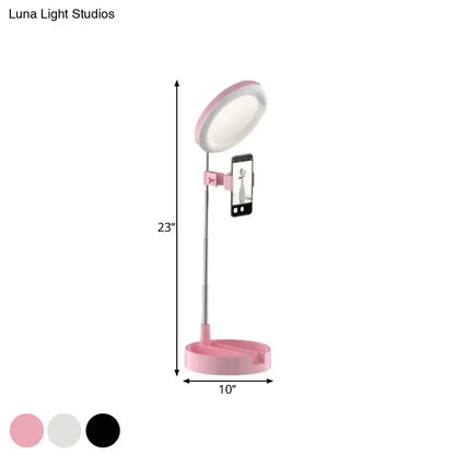 Minimalist pink circular led ring light with adjustable stand and phone clamp powered by usb power source for makeup and selfies