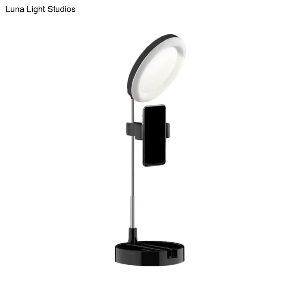 Minimalist black led ring light with phone holder and adjustable stand featuring usb power source for bedroom use