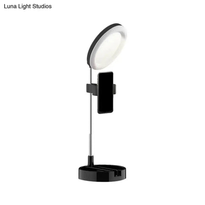 Minimalist black led ring light with phone holder and adjustable stand featuring usb power source for bedroom use
