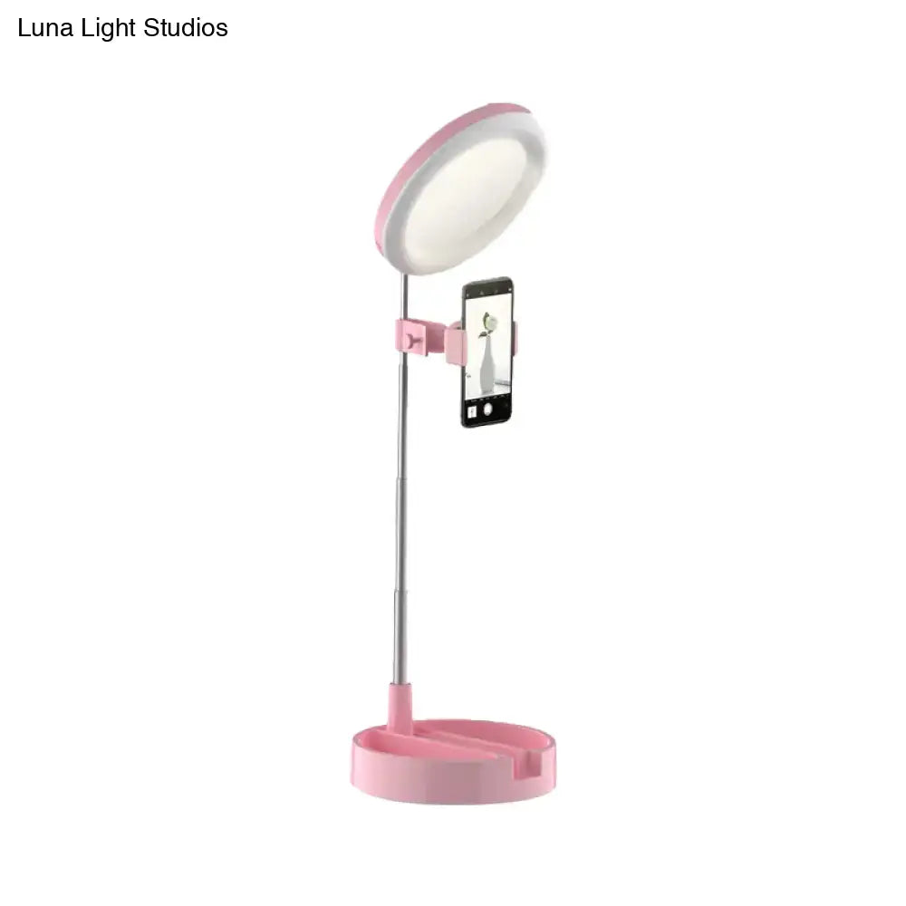 Minimalist pink circular led ring light with phone clamp for makeup and selfies featuring usb power source