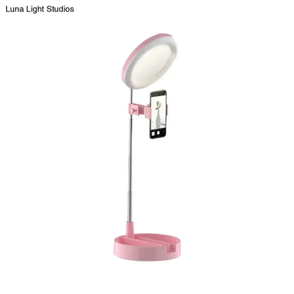 Minimalist pink circular led ring light with phone clamp for makeup and selfies featuring usb power source