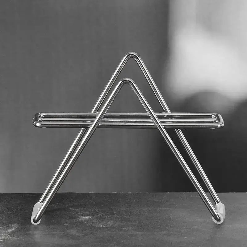 Minimalist shiny chrome triangular coffee filter holder with rounded edges and white rubber feet for kitchen use