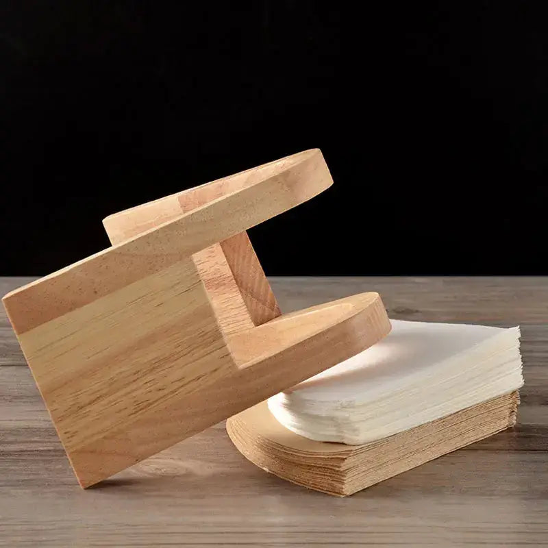 Minimalist light wood coffee filter holder with a sturdy wooden bookend design for kitchen paper dispenser use