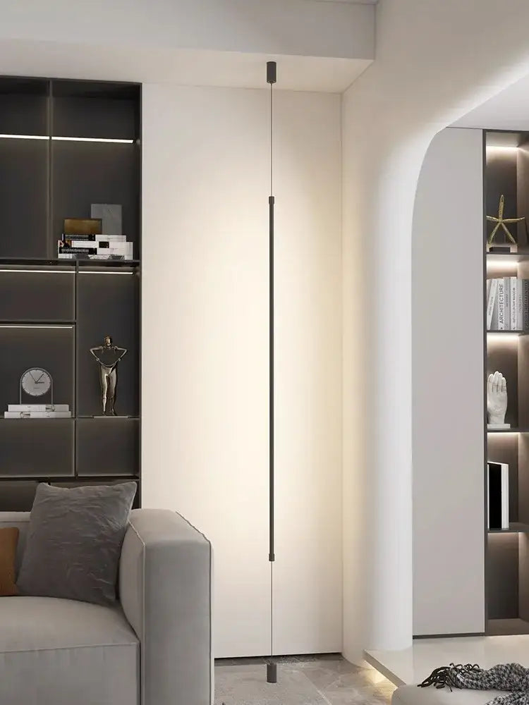 Minimalist matte black cylindrical pendant light strip with sleek vertical floor lamp design for modern bedroom lighting