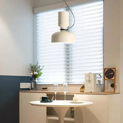 Minimalist matte black and off-white pendant light with two stacked cylinders and decorbites forged iron features