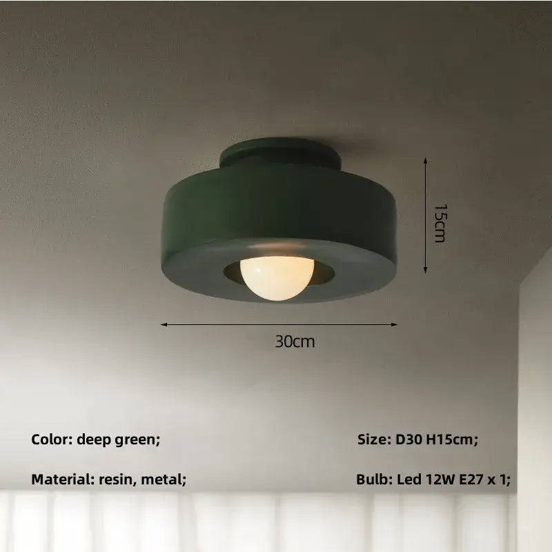 Minimalist matte black round ceiling light with deep green resin and metal flush mount design by decorbites ceiling light