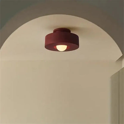 Modern circular red ceiling light with matte finish and warm glow by decorbites ceiling light for bedroom decor