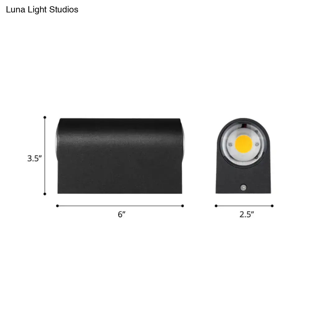 Minimalist matte black rectangular wall light with circular lens and yellow LED light source for outdoor use