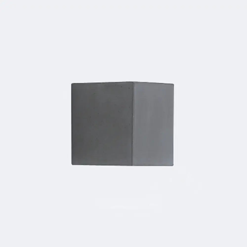 A minimalist matte gray concrete wall sconce with a square shape designed as a corridor led light block
