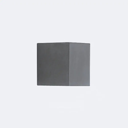 A minimalist matte gray concrete wall sconce with a square shape designed as a corridor led light block
