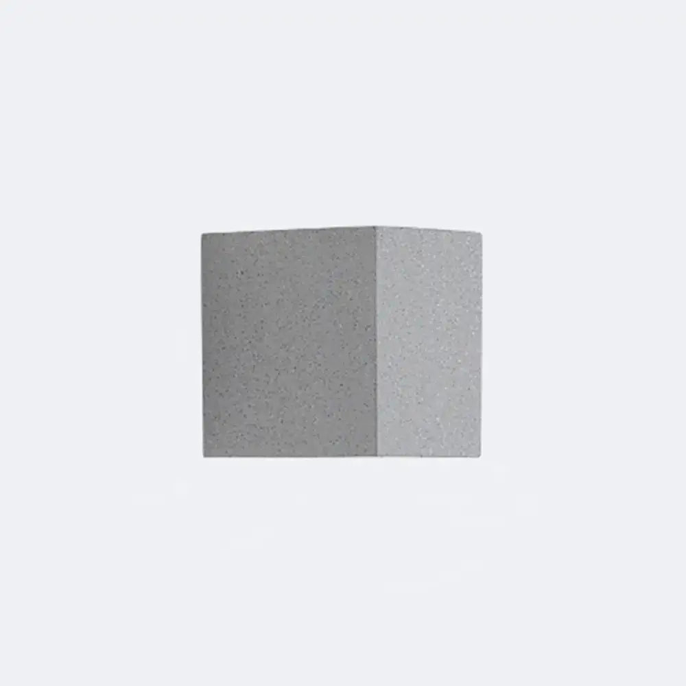 Minimalist matte gray concrete wall sconce with speckled texture and sharp edges for corridor led lighting