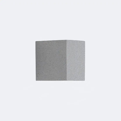 Minimalist matte gray concrete wall sconce with speckled texture and sharp edges for corridor led lighting